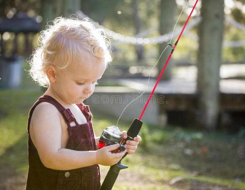 Cute Young Boy With Fishing Pole at The Lake