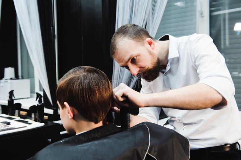 Cute Young Boy Getting a Haircut in a Salon Stock Image - Image of ...