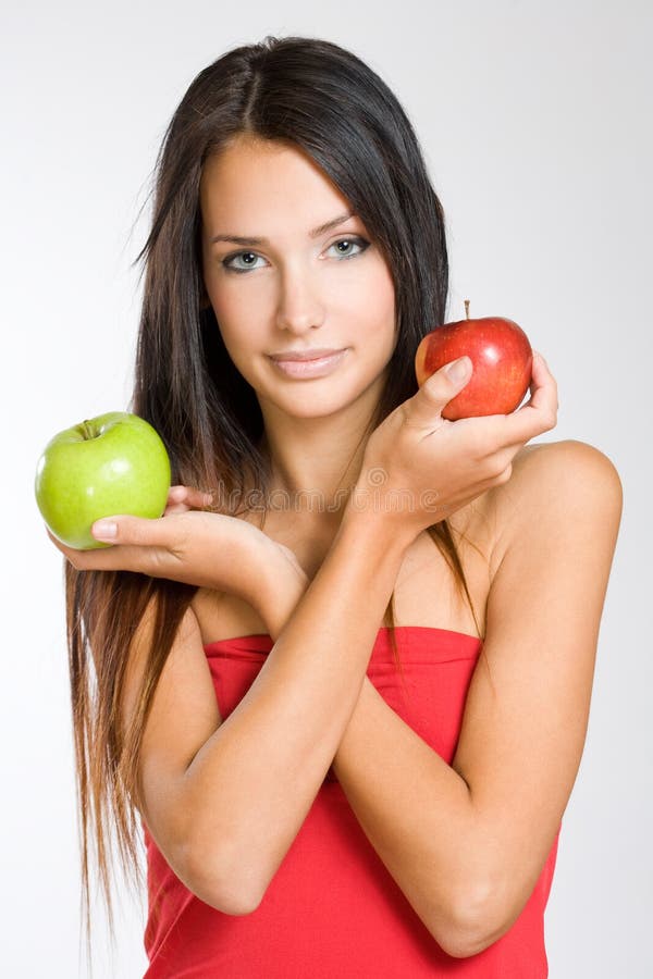Cute young brunette holding two apples. royalty free stock photo Cute young brunette holding two apples. royalty free stock photo