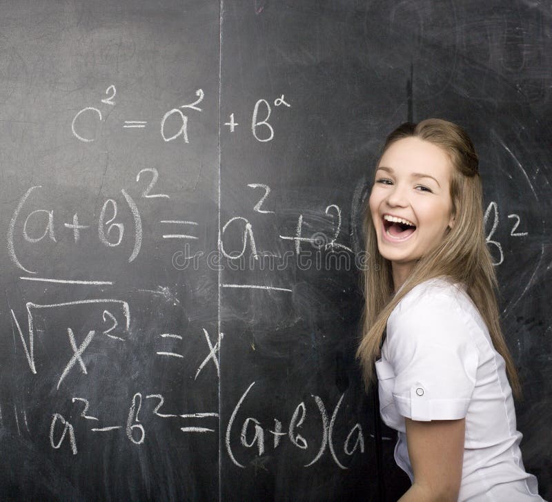 Cute young student near blackboard with copy book calculator pen, copy space