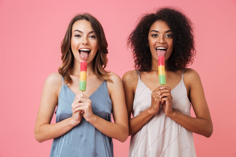 Cute young two women eating ice cream. stock images Cute young two women eating ice cream. stock images