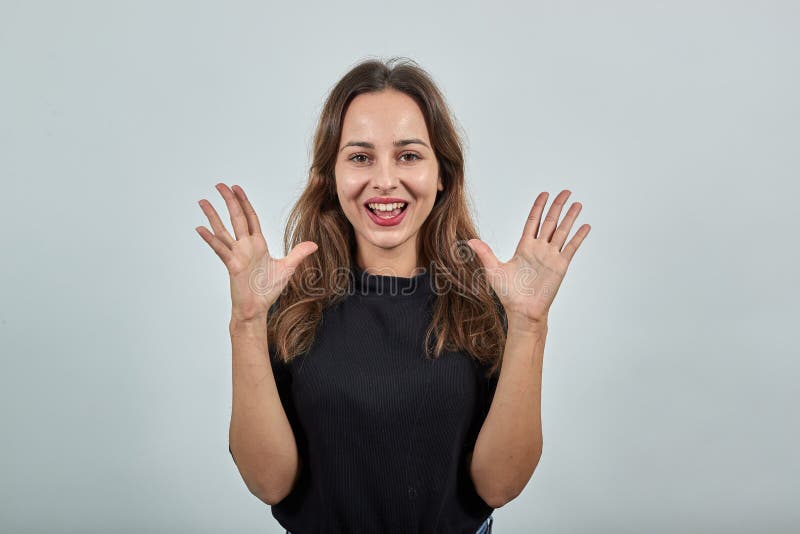 Cute Young Woman Brunette In Black T-Shirt, Smiling Happy Girl Spread Fingers royalty free stock image Cute Young Woman Brunette In Black T-Shirt, Smiling Happy Girl Spread Fingers royalty free stock image