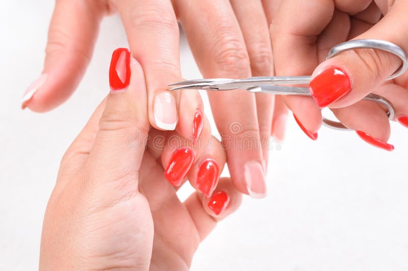 Manicure master in the work process trimming cuticles on toes with pedicure  scissors, cutters for ingrown nails. Closeup hands and feet view. Day Spa  Stock Photo - Alamy