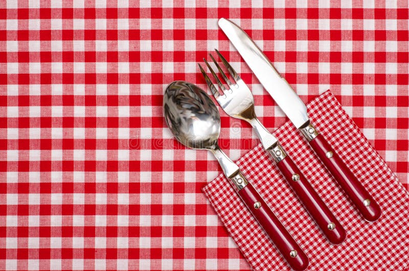 Cutlery with red knife, fork and spoon