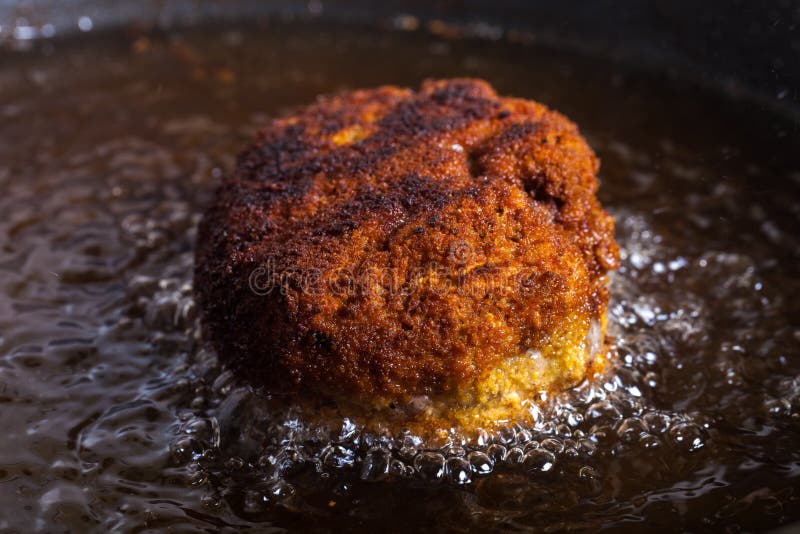 Chicken Deep Frying In Hot Oil In A Cast Iron Frying Pan Stock Photo,  Picture and Royalty Free Image. Image 17721959.