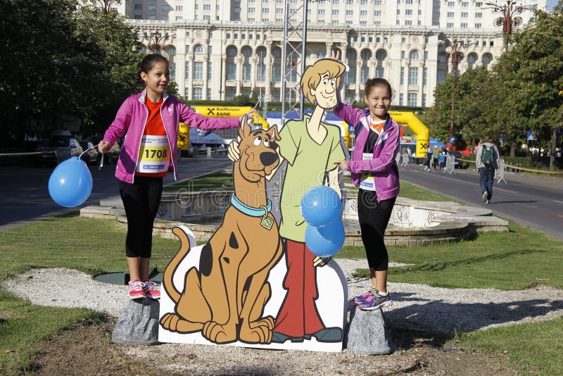 Cutout with Scooby-Doo at the Bucharest Raiffeisen International Marathon with House of the People (Casa Poporului in romanian) in background. Cutout with Scooby-Doo at the Bucharest Raiffeisen International Marathon with House of the People (Casa Poporului in romanian) in background