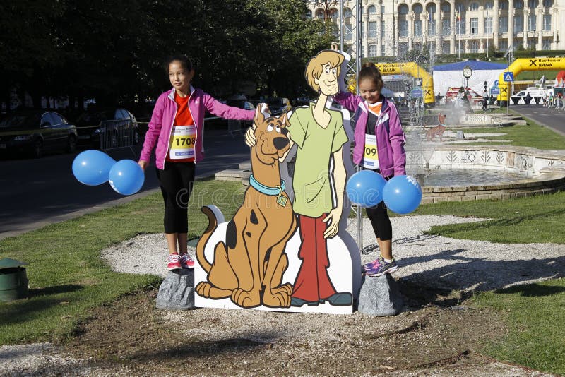 Cutout with Scooby-Doo at the Bucharest Raiffeisen International Marathon with House of the People (Casa Poporului in romanian) in background. Cutout with Scooby-Doo at the Bucharest Raiffeisen International Marathon with House of the People (Casa Poporului in romanian) in background
