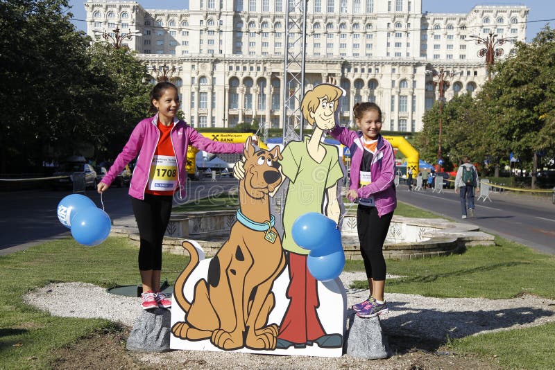 Cutout with Scooby-Doo at the Bucharest Raiffeisen International Marathon with House of the People (Casa Poporului in romanian) in background. Cutout with Scooby-Doo at the Bucharest Raiffeisen International Marathon with House of the People (Casa Poporului in romanian) in background