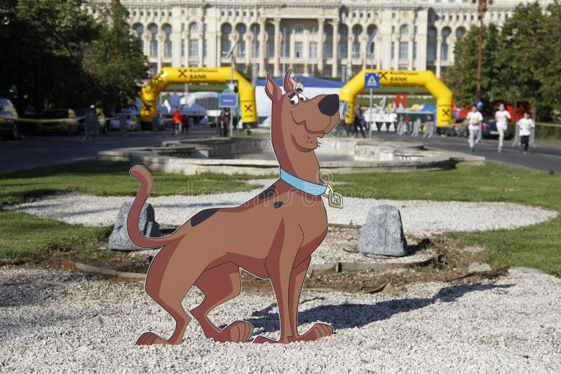 Cutout with Scooby-Doo at the Bucharest Raiffeisen International Marathon with House of the People (Casa Poporului in romanian) in background. Cutout with Scooby-Doo at the Bucharest Raiffeisen International Marathon with House of the People (Casa Poporului in romanian) in background