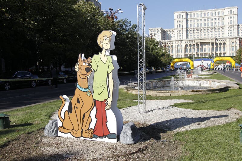 Cutout with Scooby-Doo at the Bucharest Raiffeisen International Marathon with House of the People (Casa Poporului in romanian) in background. Cutout with Scooby-Doo at the Bucharest Raiffeisen International Marathon with House of the People (Casa Poporului in romanian) in background