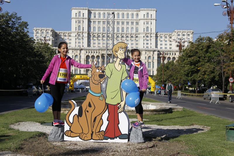 Cutout with Scooby-Doo at the Bucharest Raiffeisen International Marathon with House of the People Casa Poporului in romanian in background. Cutout with Scooby-Doo at the Bucharest Raiffeisen International Marathon with House of the People Casa Poporului in romanian in background