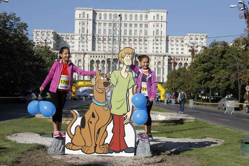 Cutout with Scooby-Doo at the Bucharest Raiffeisen International Marathon with House of the People (Casa Poporului in romanian) in background. Cutout with Scooby-Doo at the Bucharest Raiffeisen International Marathon with House of the People (Casa Poporului in romanian) in background