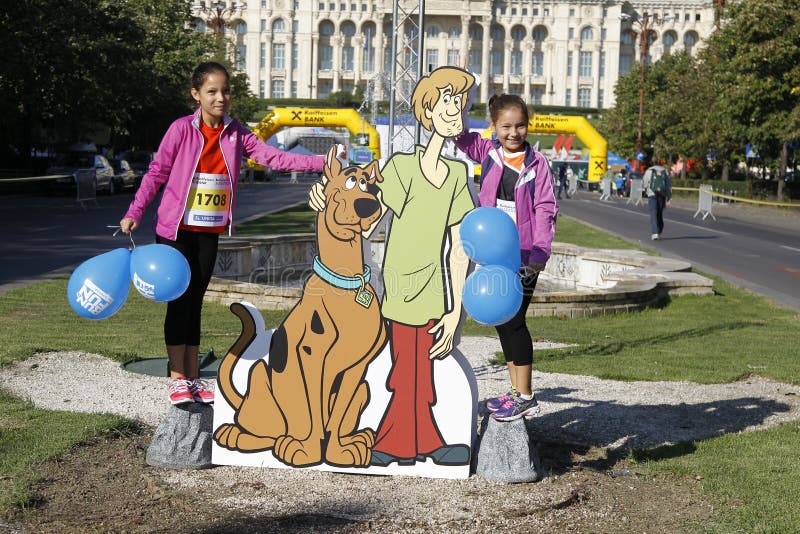 Cutout with Scooby-Doo at the Bucharest Raiffeisen International Marathon with House of the People Casa Poporului in romanian in background. Cutout with Scooby-Doo at the Bucharest Raiffeisen International Marathon with House of the People Casa Poporului in romanian in background