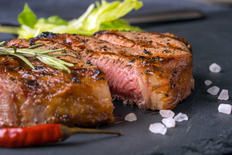 A ribeye steak with green stock image. Image of black 137200493