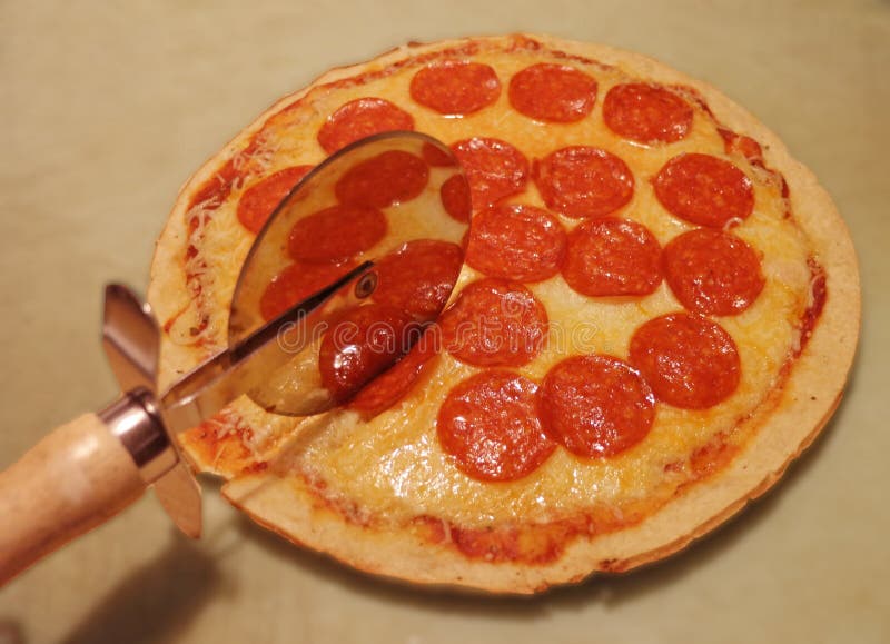 Cutter on a Freshly Cooked Pepperoni Pizza Stock Image Image of