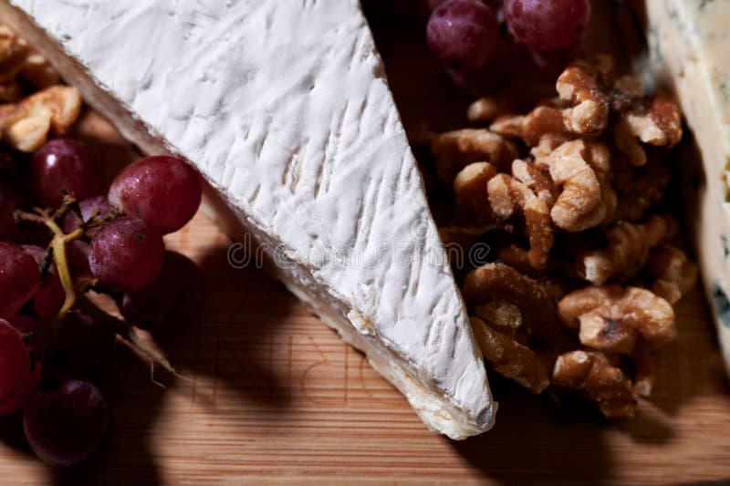 Cutting Board with a Selection of Grapes and Cheese on Display Stock