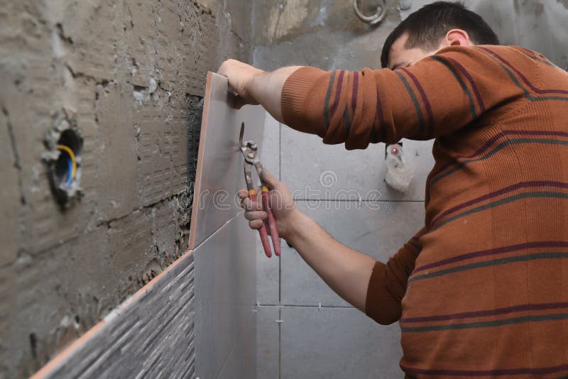 Cutting Ceramic Tiles. a Worker Places a Large Tile in a Machine Stock Image Image of industry