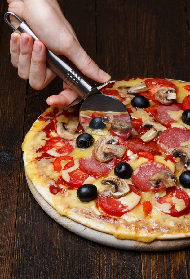 Cutting pizza stock image. Image of bake, rosemary, dinner 27025903