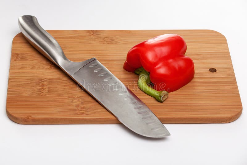 Cutting the Vegetables with a Kitchen Knife on the Board Stock Photo