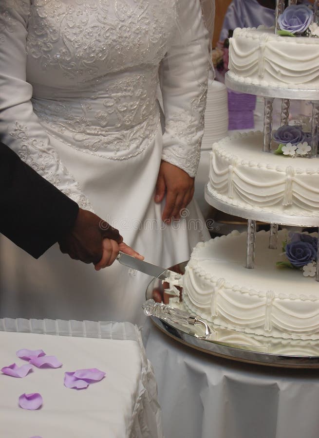 Cutting a wedding cake stock image. Image of ceremony 4455773