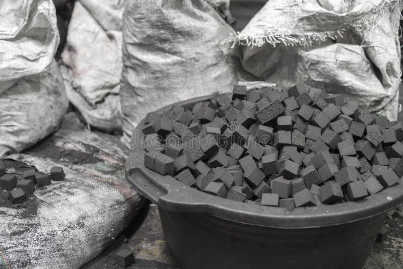 Bowl of charcoal cubes for hookah with bags. Bowl of charcoal cubes for hookah with bags