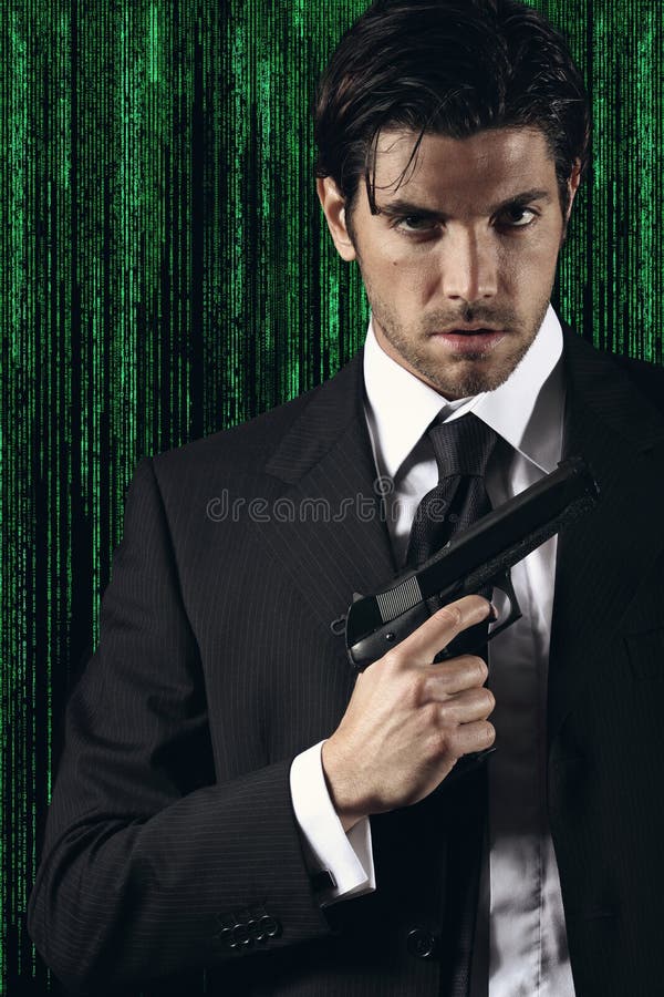 Elegant cyber spy posing with gun in hand. Green matrix background portrait.