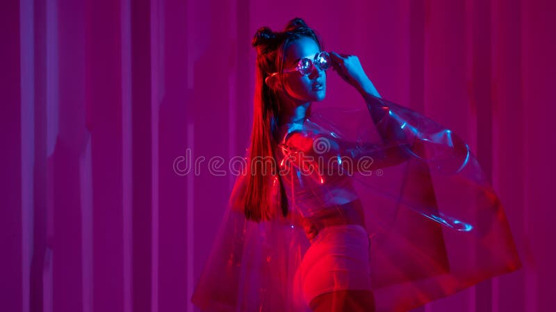 Cyberpunk and neon, a young trend girl in a transparent latex raincoat. Futuristic neon style. Stylish young woman with glasses and hairdo in Asian anime style. Cyberpunk and neon, a young trend girl in a transparent latex raincoat. Futuristic neon style. Stylish young woman with glasses and hairdo in Asian anime style.