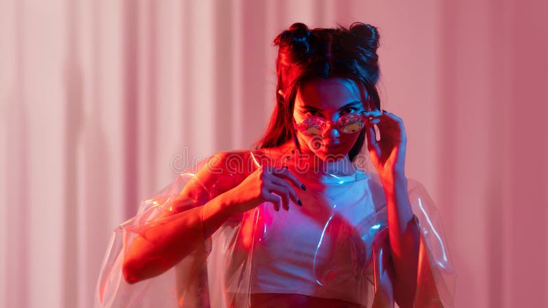 Cyberpunk and neon, a young trend girl in a transparent latex Cape. Futuristic neon style, bright red backlight. Cyberpunk and neon, a young trend girl in a transparent latex Cape. Futuristic neon style, bright red backlight.