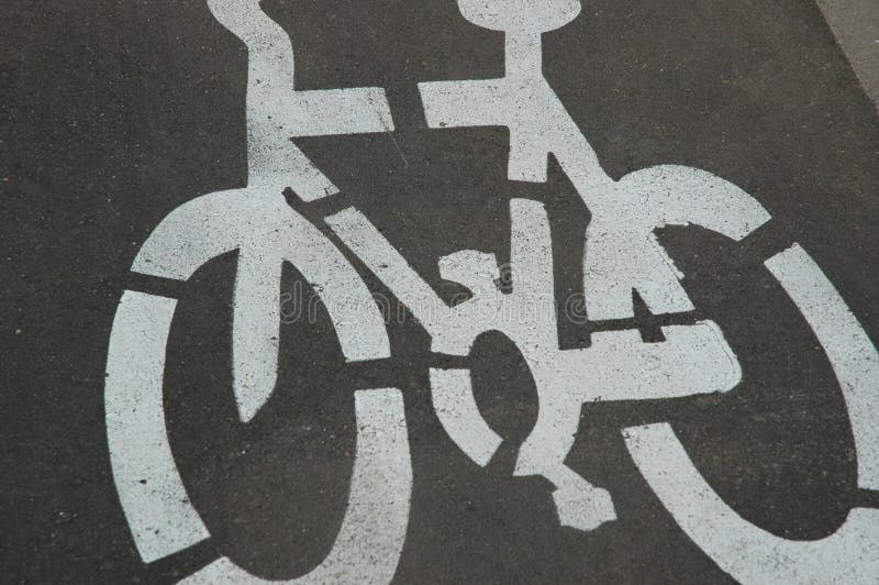 Cycle Road Symbol. Close-up of white painted symbol of a cycle. It is situated on the tarmac in a bike lane stock image Cycle Road Symbol. Close-up of white painted symbol of a cycle. It is situated on the tarmac in a bike lane stock image