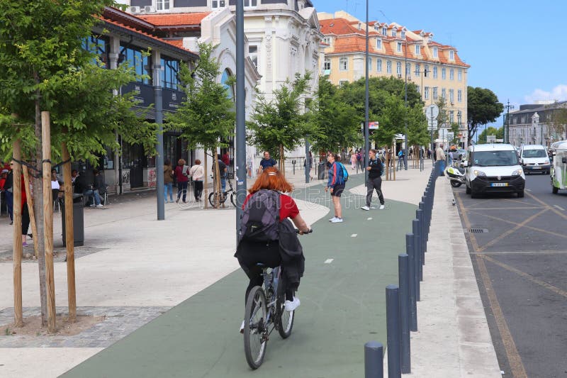 LISBON, PORTUGAL - JUNE 6, 2018: Cyclist rides along a bicycle route in Lisbon, Portugal. Lisbon is the 11th-most populous urban area in the EU 2.8 million people. LISBON, PORTUGAL - JUNE 6, 2018: Cyclist rides along a bicycle route in Lisbon, Portugal. Lisbon is the 11th-most populous urban area in the EU 2.8 million people