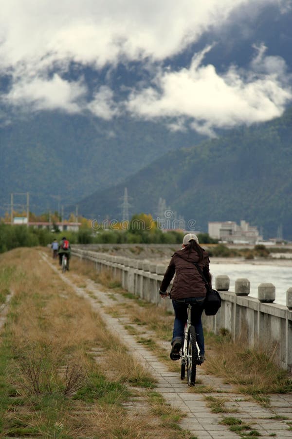 Cycling by the riverside in deep tibet valley