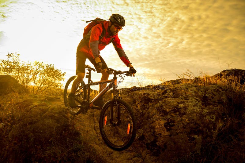 Cyclist in Red Riding the Bike on Autumn Rocky Trail at Sunset. Extreme ...