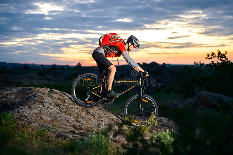 Cyclist Riding the Bike Down Hill on Mountain Rocky Trail at Sunset ... - Cyclist RiDing Bike Down Hill Mountain Rocky Trail Sunset 73681248