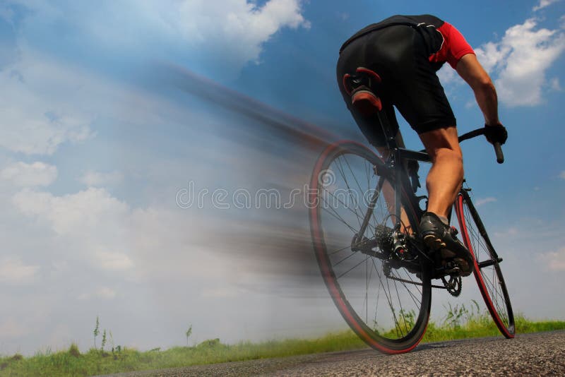 Cyclist riding fast on the asphalt road stock images Cyclist riding fast on the asphalt road stock images