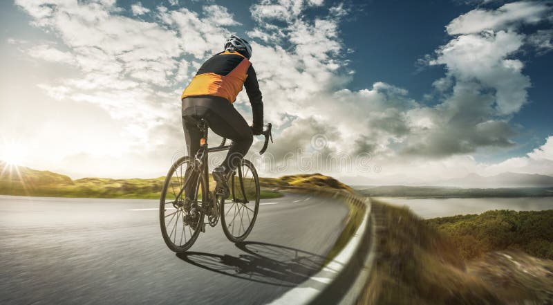 Cyclist on a road at full speed stock image Cyclist on a road at full speed stock image