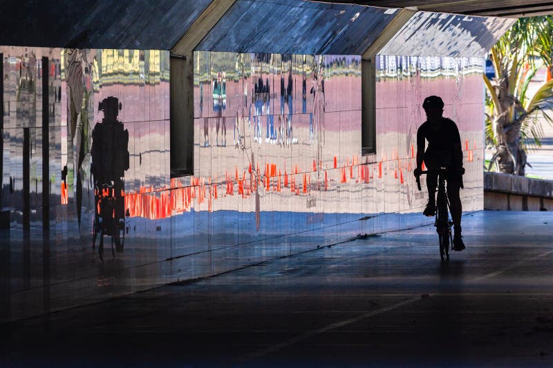 Cyclist Silhouetted Riding Tunnel Reflections royalty free stock photos