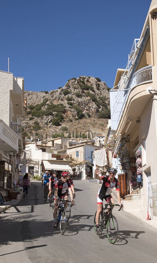 Cyclists touring Crete passing through the village of Kritsa stock photo Cyclists touring Crete passing through the village of Kritsa stock photo