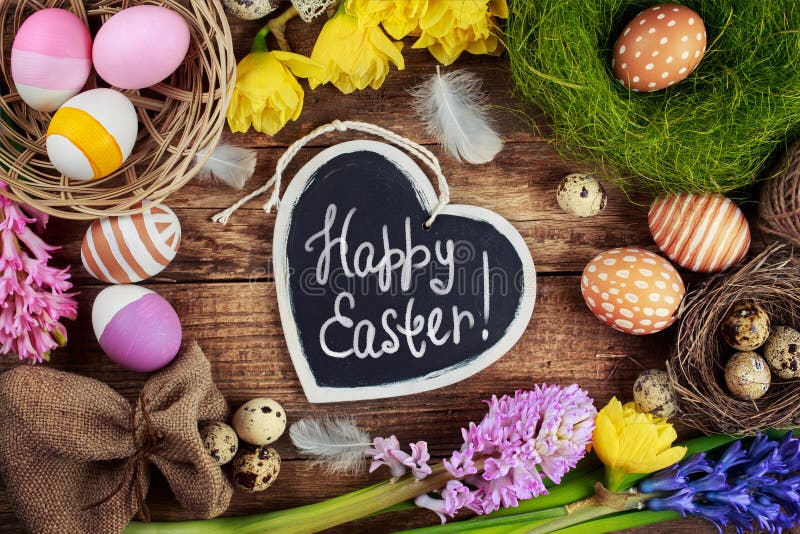 Black board with text - Happy Easter. Colorful Easter Eggs and flowers. Black board with text - Happy Easter. Colorful Easter Eggs and flowers