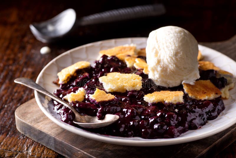 A delicious homemade blueberry cobbler with a scoop of vanilla ice cream. A delicious homemade blueberry cobbler with a scoop of vanilla ice cream.