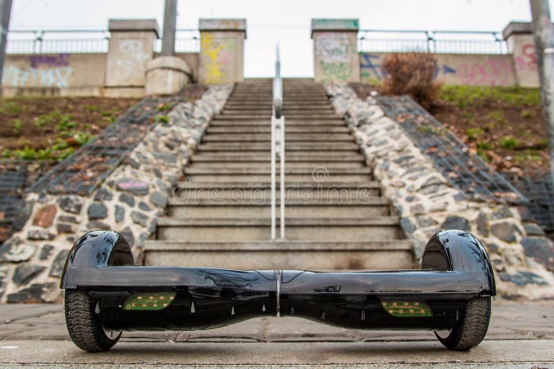 A black hoverboard against the background of stairs. A black hoverboard against the background of stairs
