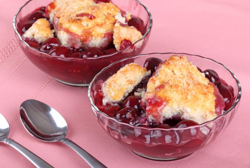 Two glass bowls of homemade cherry cobbler. Two glass bowls of homemade cherry cobbler