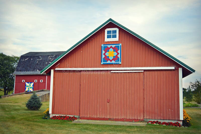 A red barn and a red outbuilding that both have decorative quilt patterns on the front of them. Located in Walworth County, Wisconsin. A red barn and a red outbuilding that both have decorative quilt patterns on the front of them. Located in Walworth County, Wisconsin.