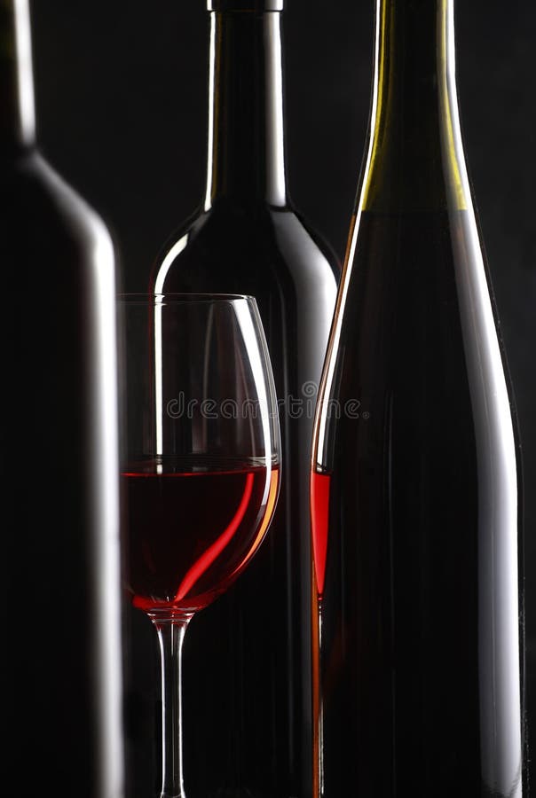 Still life with red wine on dark background with bottle. Still life with red wine on dark background with bottle