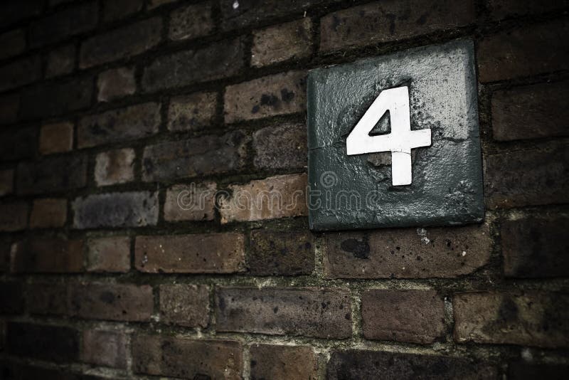 Number four on a brick wall in London. Number four on a brick wall in London