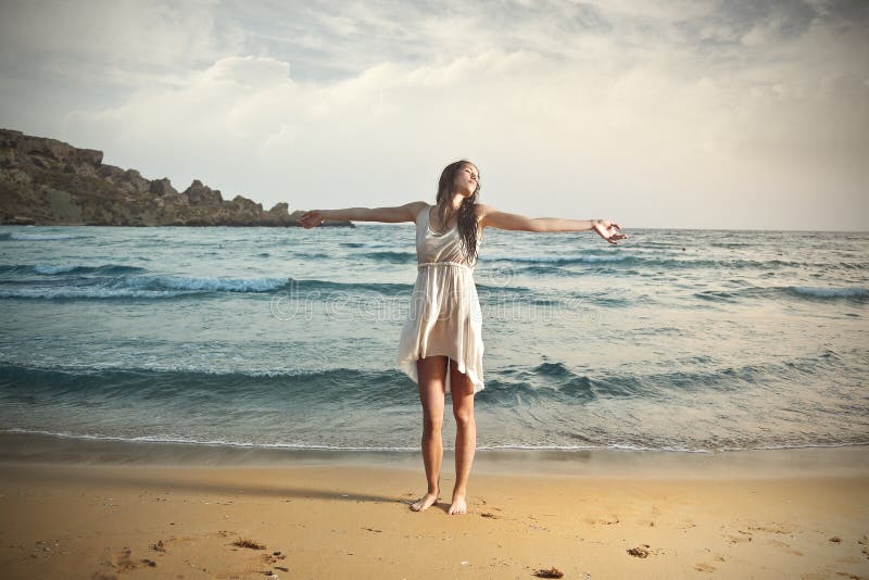 Young girl at the beach feeling free. Young girl at the beach feeling free