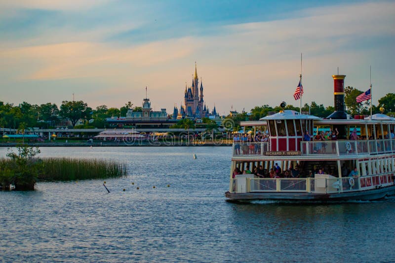 Orlando, Florida. April 23, 2019. Partial view of Cinderella`s Castle and Disney Ferry boat on colorful sunset bakcground at Walt Disney World  area  1. Orlando, Florida. April 23, 2019. Partial view of Cinderella`s Castle and Disney Ferry boat on colorful sunset bakcground at Walt Disney World  area  1