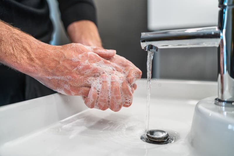 Corona virus travel prevention man showing hand hygiene washing hands with soap in hot water for coronavirus germs spreading protection. Corona virus travel prevention man showing hand hygiene washing hands with soap in hot water for coronavirus germs spreading protection.