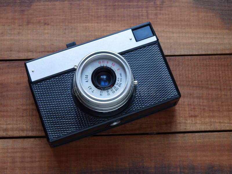 An old russian camera on a wooden table. An old russian camera on a wooden table.