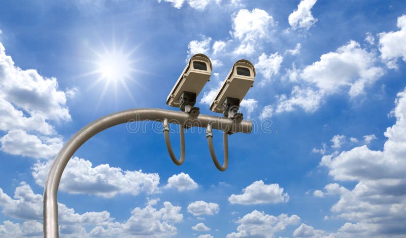 Outdoor Security cctv cameras under Sun shine and White cloud in blue sky. Outdoor Security cctv cameras under Sun shine and White cloud in blue sky