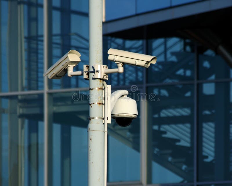 cameras on front of modern glass building. cameras on front of modern glass building